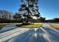 Circular residential concrete driveway in front of a brick home — Old North Concrete Co.