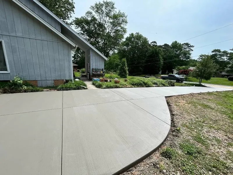 Curved broom-finish concrete driveway with crisp control joints — Old North Concrete Co.