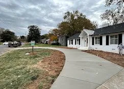Residential broom-finish concrete driveway in a suburban neighborhood — Old North Concrete Co.