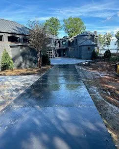 Freshly poured concrete driveway being edged and broom-finished — Old North Concrete Co.