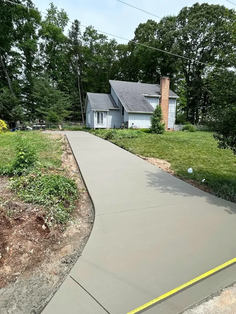 Long curved residential concrete driveway leading up to a Lake Norman lakefront home — Old North Concrete Co.