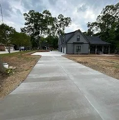 Freshly poured concrete driveway at a new-construction home — Old North Concrete Co.