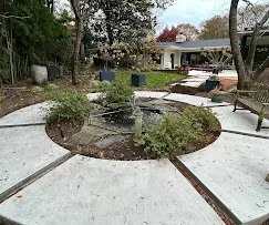 Circular concrete patio surrounded by landscaped beds — Old North Concrete Co.