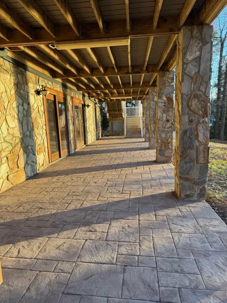 Finished stamped concrete patio in warm earth tones at a Lake Norman home — Old North Concrete Co.