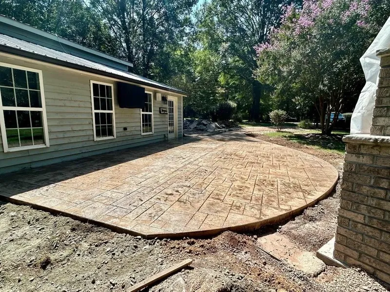 Stamped concrete patio framed by brick columns — Old North Concrete Co.