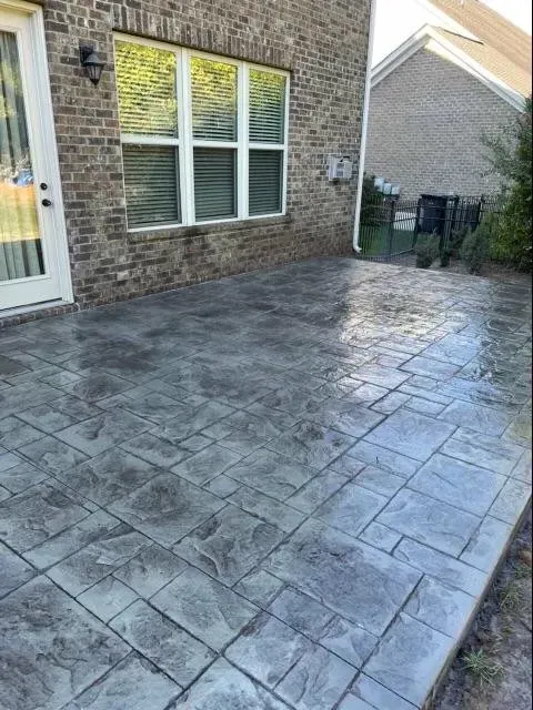 Stamped concrete patio in a dark slate finish with clean control joints — Old North Concrete Co.