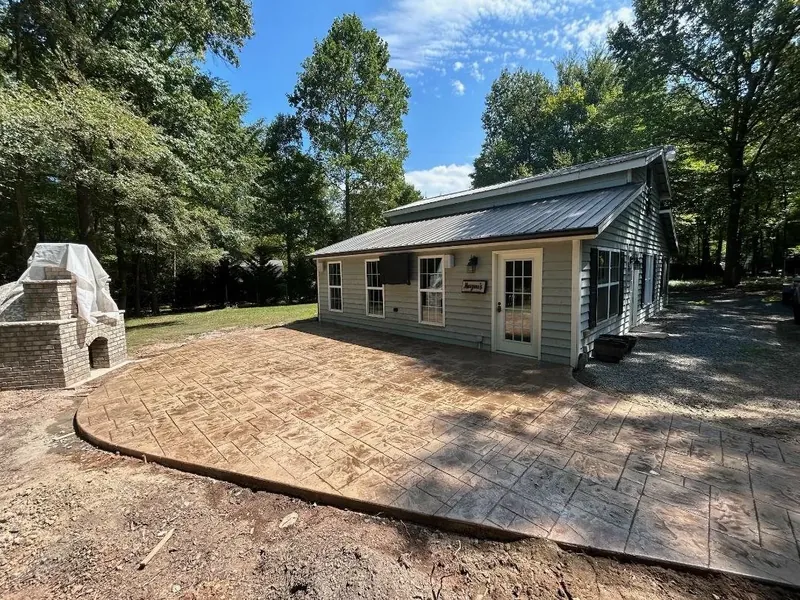 Stamped concrete patio with outdoor fireplace, ashlar slate pattern — Old North Concrete Co.