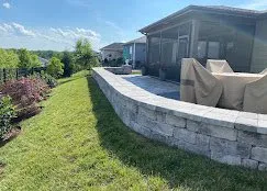 Poured concrete landscape retaining wall bordering a backyard patio — Old North Concrete Co.